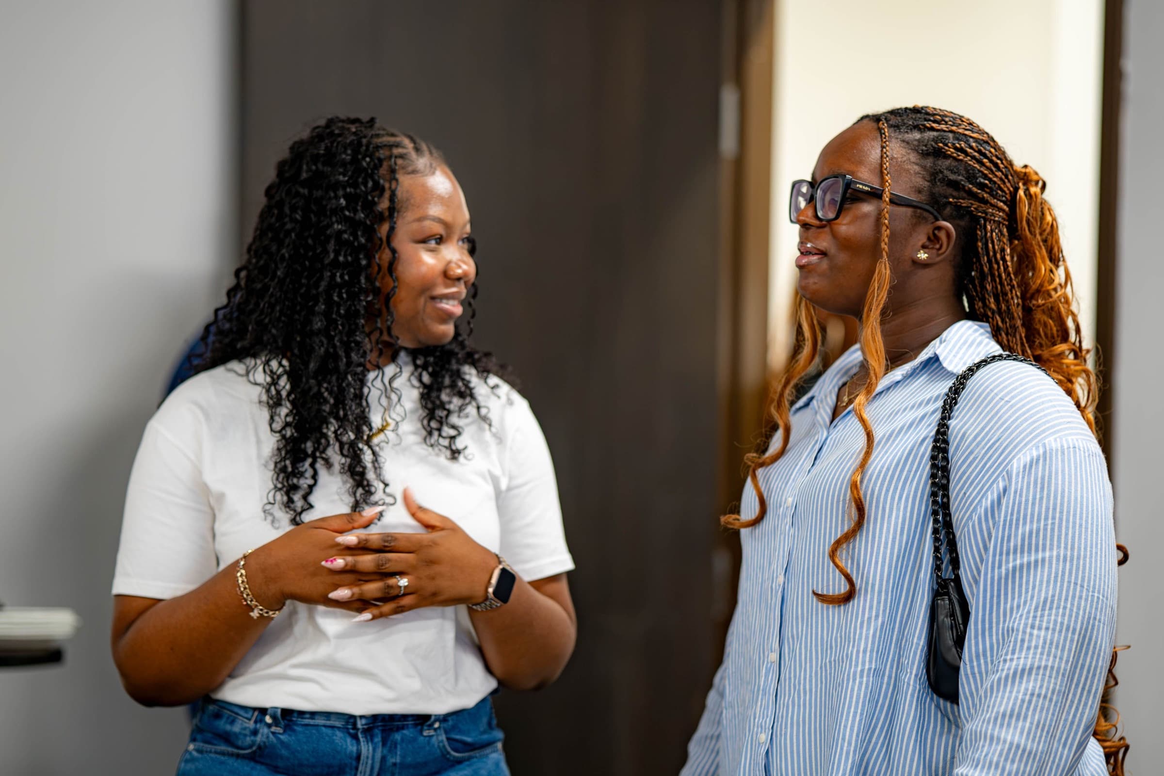 Two women talking together in the Green Room after a Sunday service.